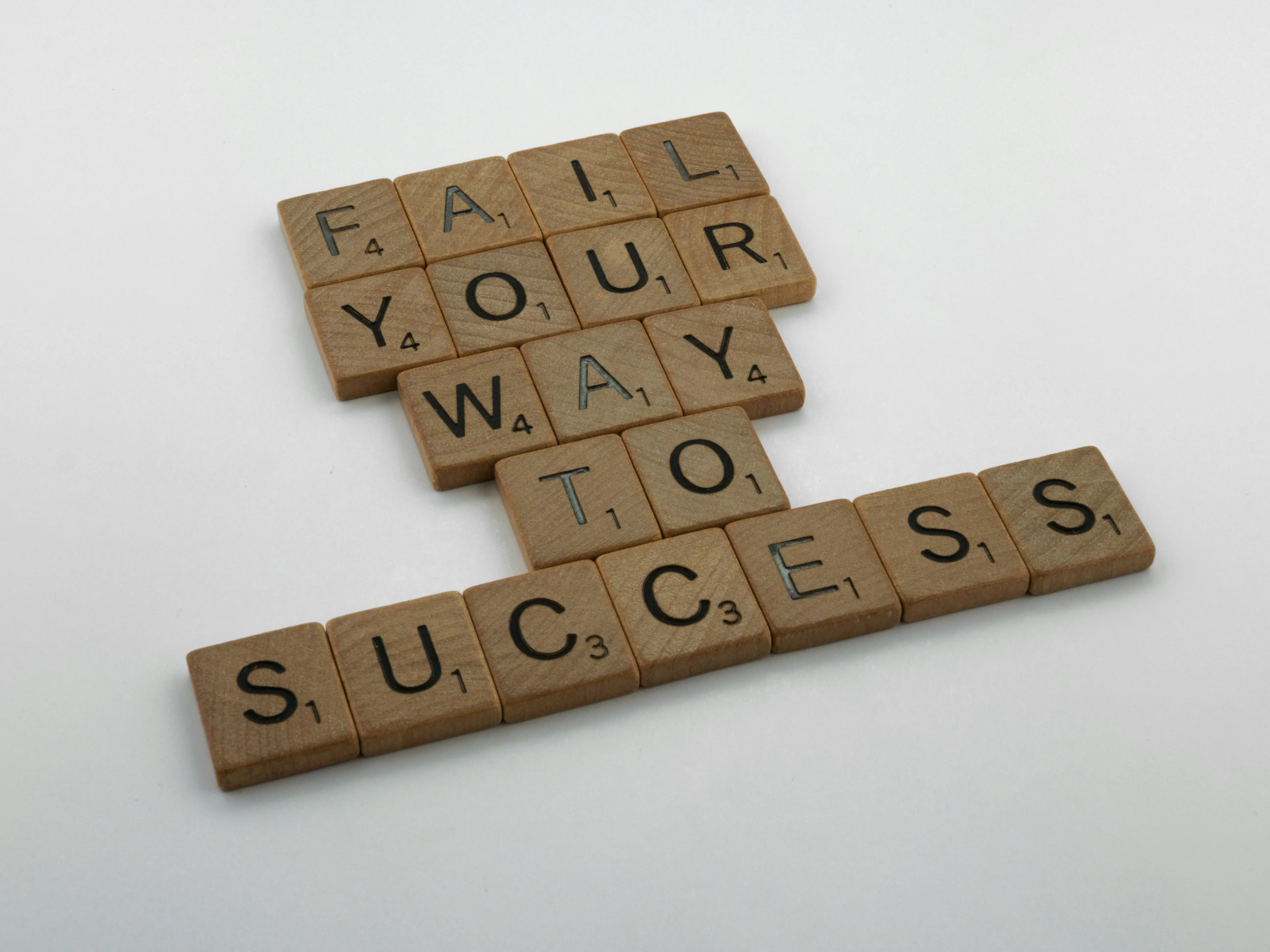 Scrabble tiles that spell out Fail Your Way To Success