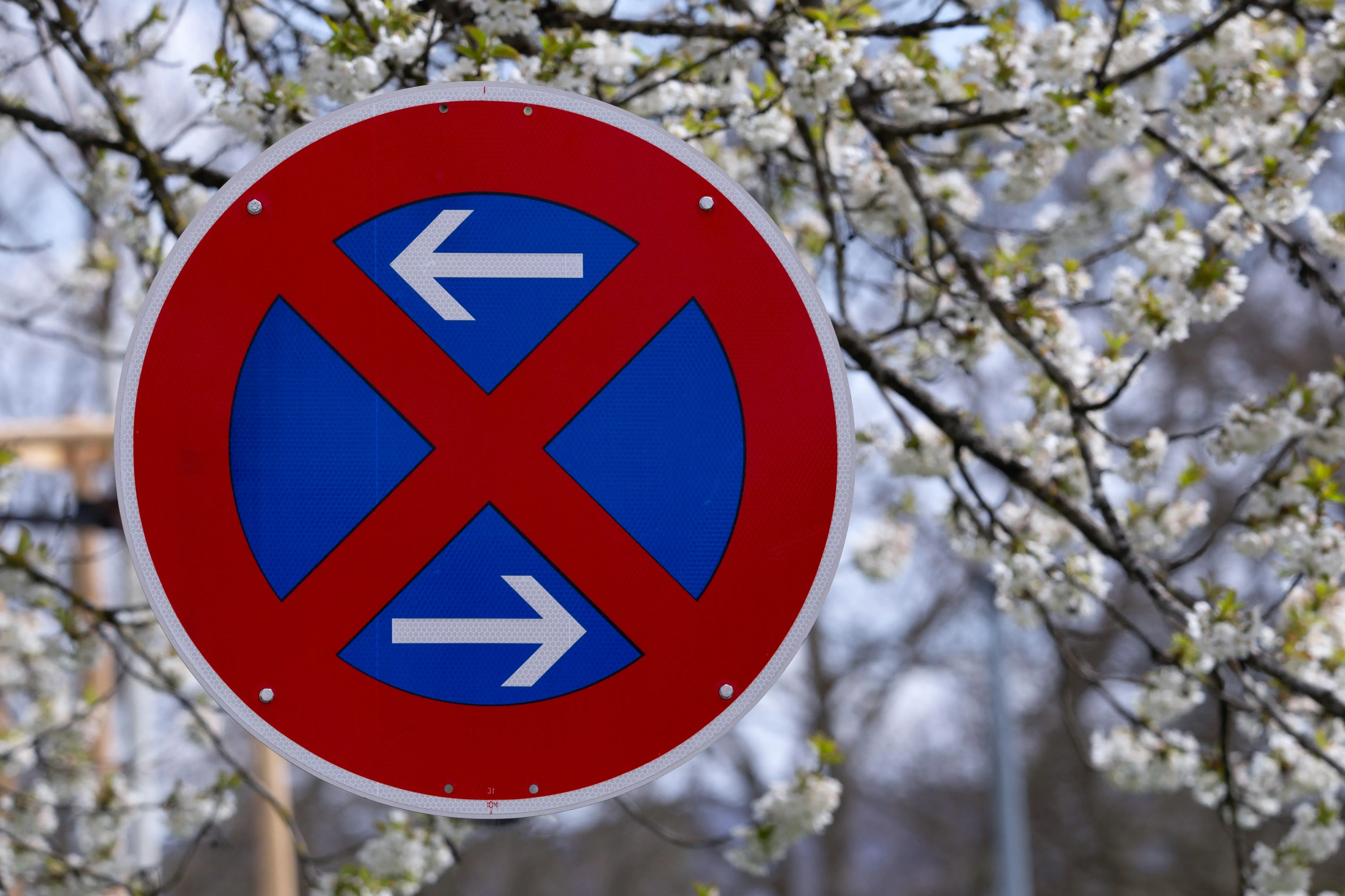A street sign with arrows pointing in different directions with a red x over them