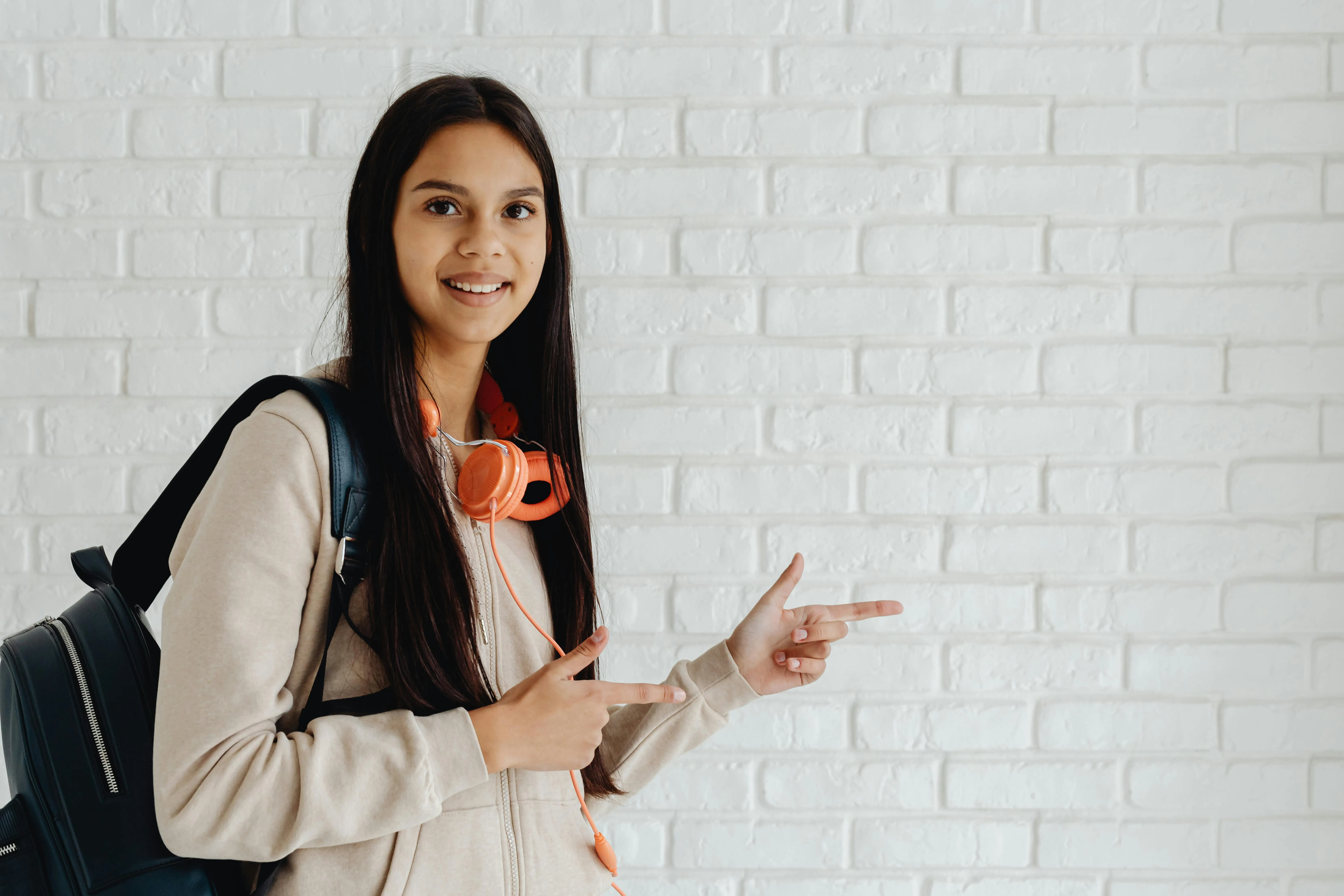 A Young woman pointing her fingers to the right