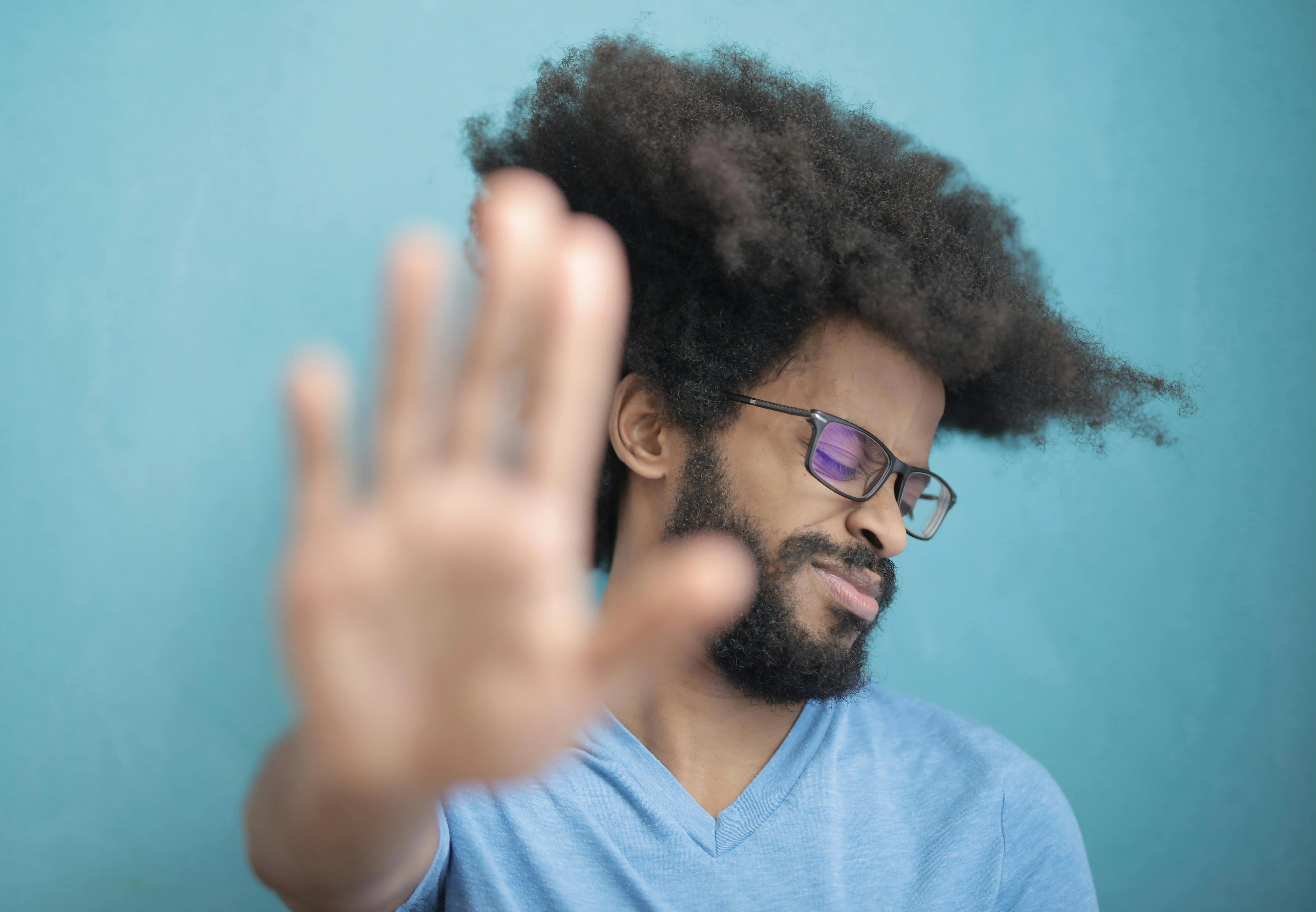 a man holding his hand out to say no