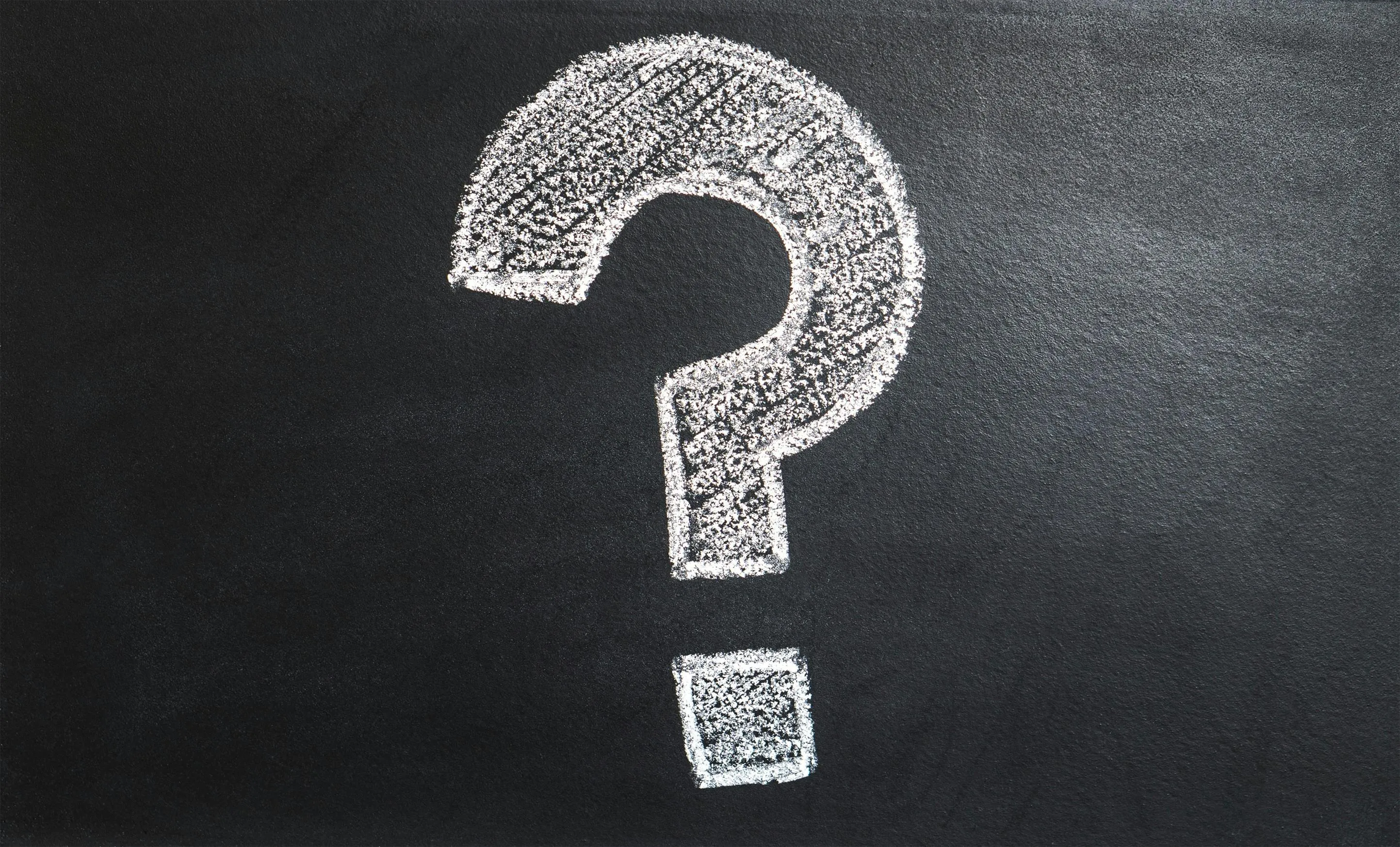 A question mark drawn on a blackboard.