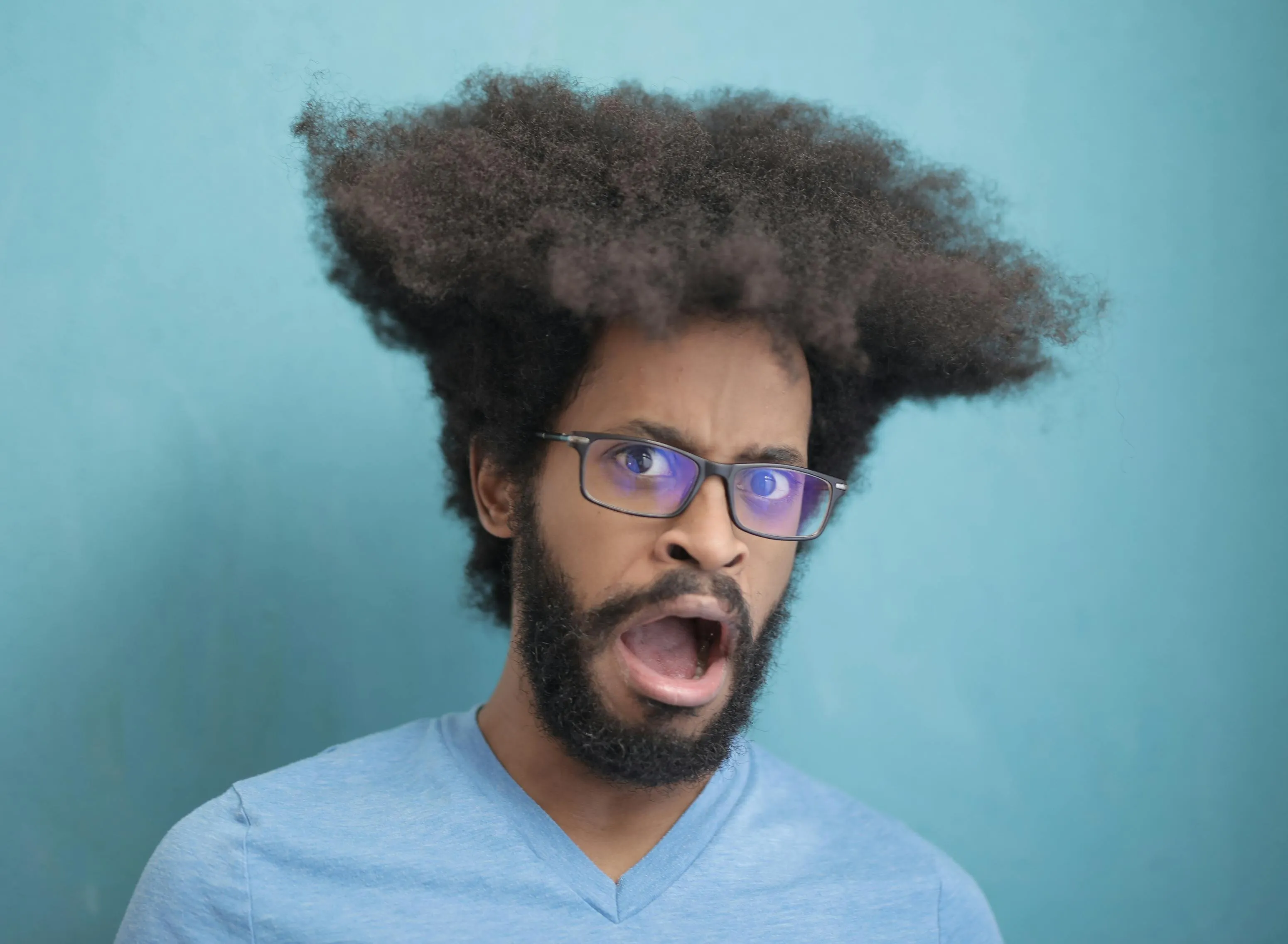 A young man making a shocked face.
